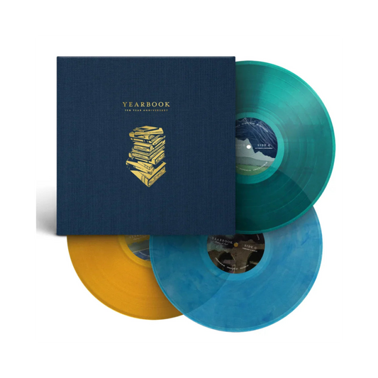 Vinyl records with colorful sleeves and a blue cover featuring 'Yearbook' branding from Sleeping At Last.